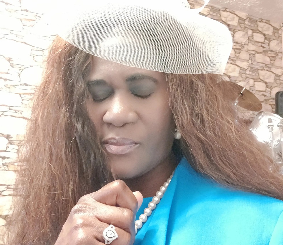 A Woman With Flowing Long Hair and a Chic White Hat